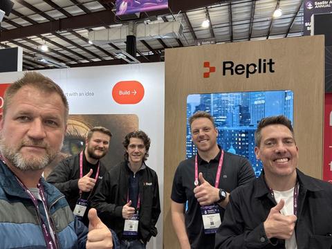 James with four people at the Replit booth at a conference